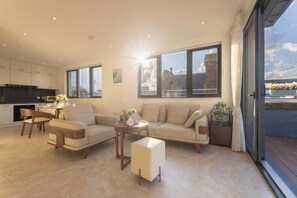 Deluxe Triple Room, 3 Bedrooms, City View | Living area | Heated floors