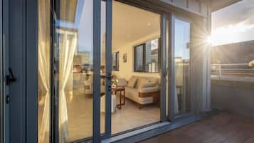 Deluxe Triple Room, 3 Bedrooms, City View | Living area | Heated floors