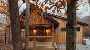 A wooden cabin with a porch, a fireplace, and a number '9' on the door.