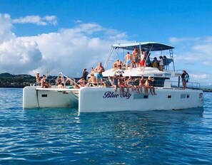 A boat with the name 'Blue Sky' on its side, filled with people enjoying the water. - V02a Casa Preciosa  · Villa with 2 Level Pool with Jet Tub (Sosua)