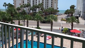 A pool area with a view of tall buildings and a beach. - Pelican Pointe 323:Walk to Beach~Pool~Free Parking (Clearwater Beach)
