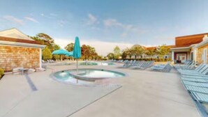 A pool area with lounge chairs and umbrellas. - Large, beautiful house! 1.5 miles to Bethany Beach! Resort style amenities!!! (Ocean View)
