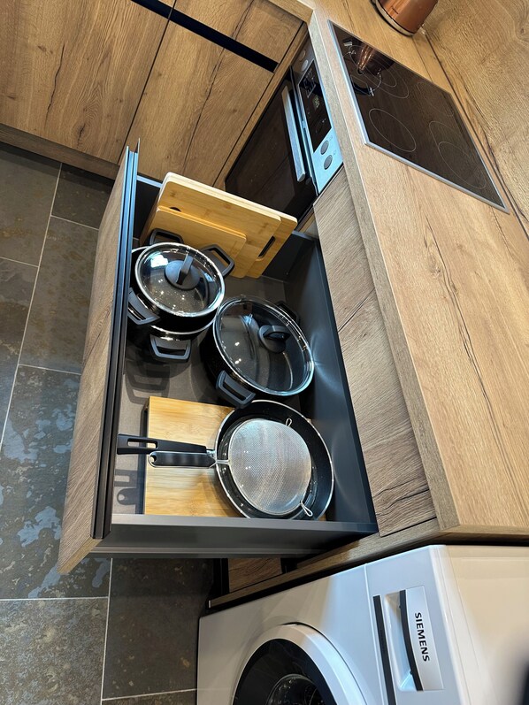 A kitchen with a built-in stove, a microwave, and a Siemens washing machine.