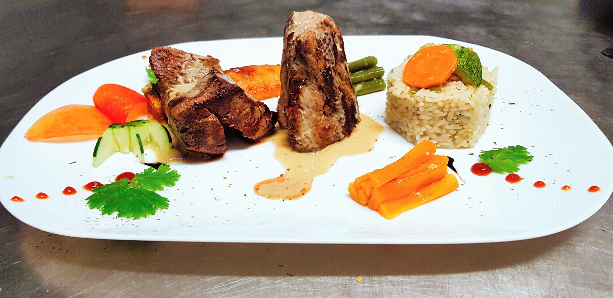 A plated meal with grilled meat, vegetables, and rice.