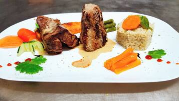 A plated meal with grilled meat, vegetables, and rice.