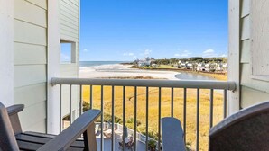 A balcony with a view of a beach and a body of water. - ONE More Sandy Day - 2BR/2BA Beach Condo, Sleeps 6 (Myrtle Beach)