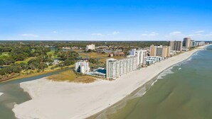 A coastal hotel with a beach view, multiple high-rise buildings, and a sandy shoreline. - ONE More Sandy Day - 2BR/2BA Beach Condo, Sleeps 6 (Myrtle Beach)