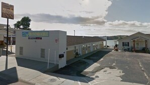 Un motel con un cartel que dice 'Bridges View Inn' y un edificio de oficinas.