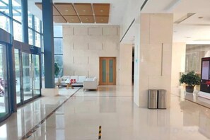 A spacious lobby with a modern design, featuring a reception desk, seating area, and a large window. - Four Points by Sheraton (Beijing Branch) (Beijing)