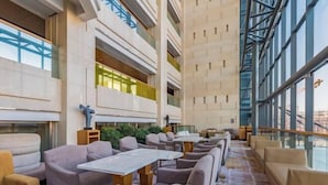 A spacious hotel lobby with high ceilings, multiple seating areas, and large windows offering views of the outdoors. - Four Points by Sheraton (Beijing Branch) (Beijing)