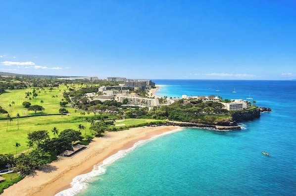 A coastal resort with beachfront properties, a golf course, and ocean views.