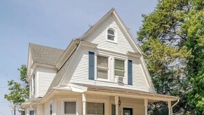A two-story white house with a front porch and a small front yard. - The Carew House Sleeps 10 Fenced 4BR Full Kitchen Steps2 YCP (York)