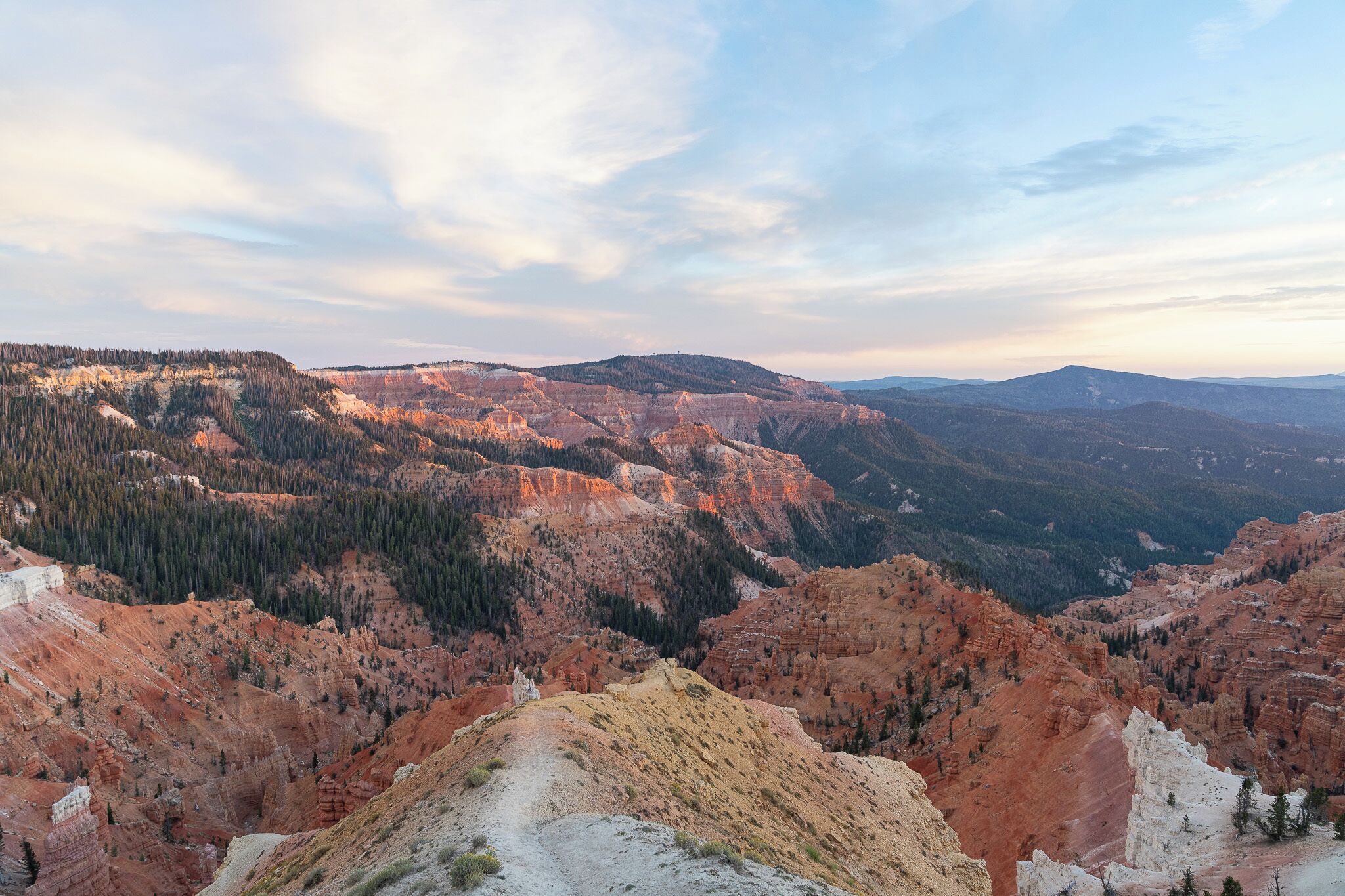 A panoramic view of a mountainous landscape with a clear sky.