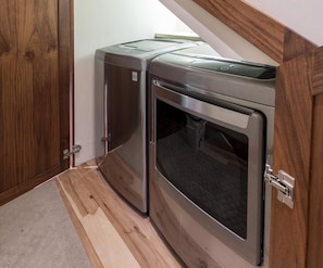 A compact kitchenette with a built-in oven and microwave, wooden cabinetry, and a small countertop.