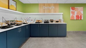 A breakfast bar with various food items and a sign that reads "Delight in the day". - Spark By Hilton Grand Prairie (Grand Prairie)