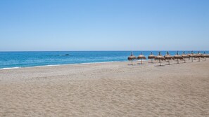 Guests can enjoy a serene beach experience with access to the calm sea.