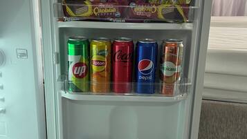A refrigerator stocked with various beverages and snacks.