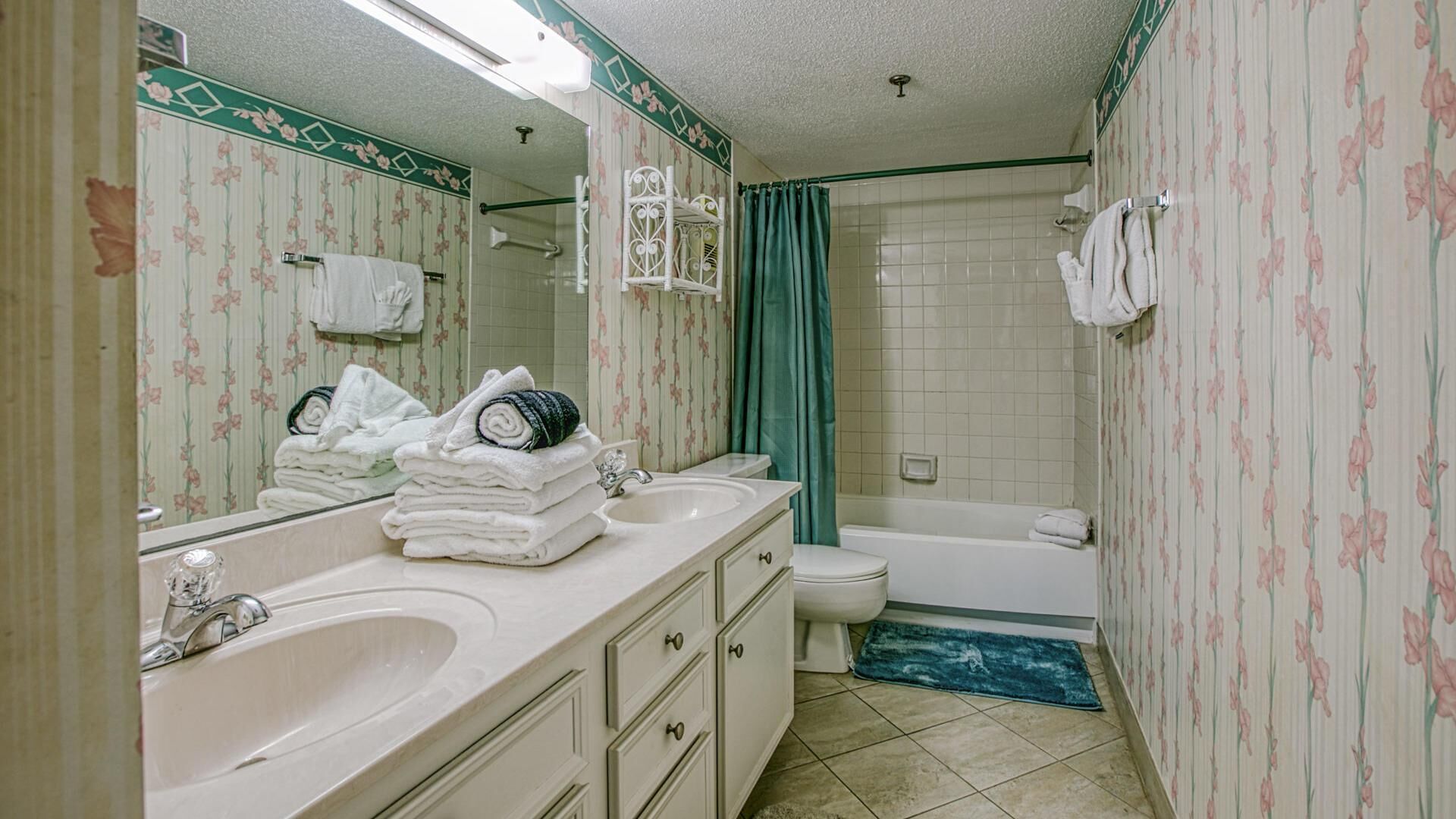 A bathroom with a sink, mirror, and toilet.