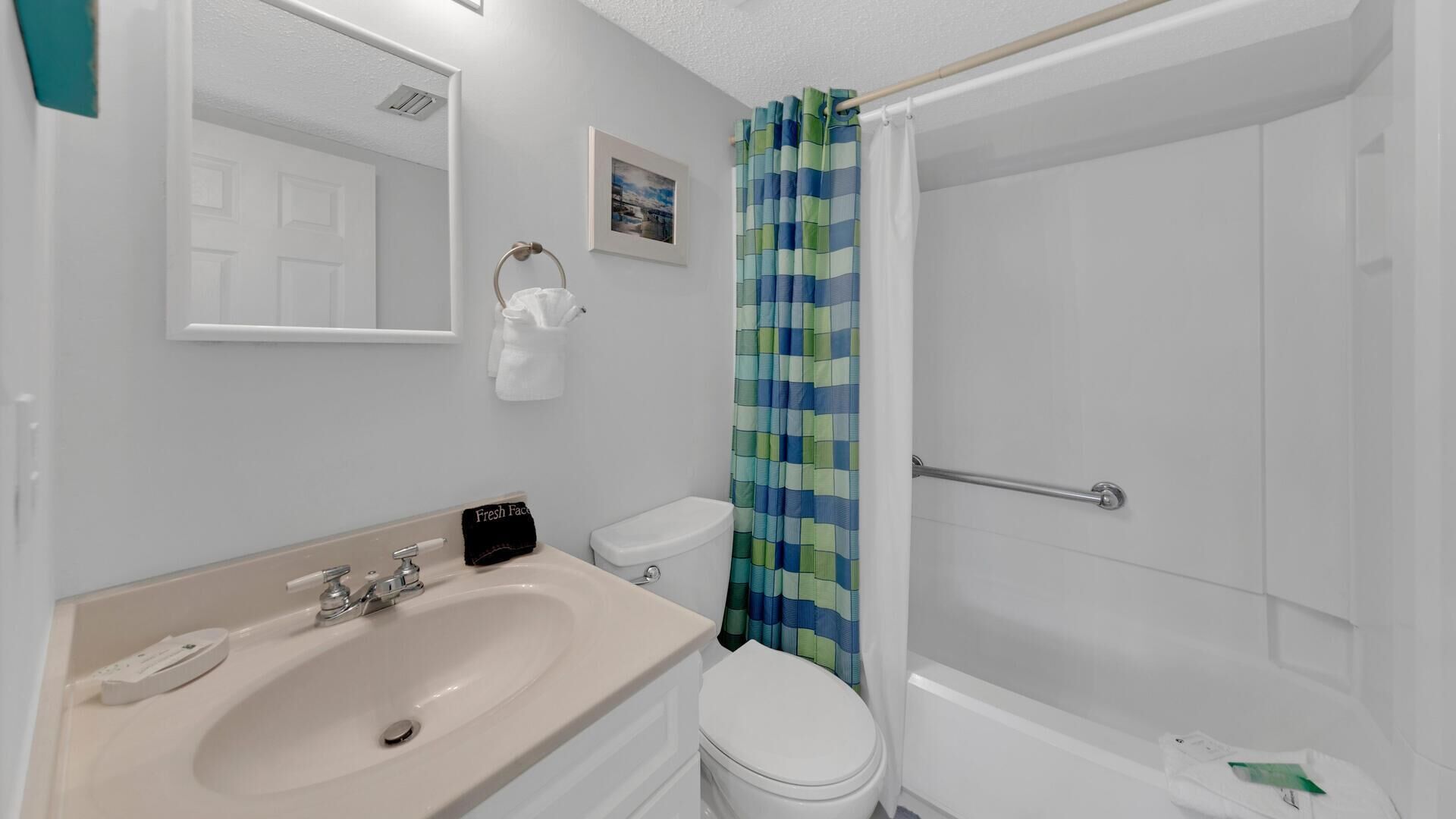 A bathroom with a sink, toilet, and shower.