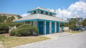 A small, single-story building with a blue and white color scheme, a metal roof, and a small porch area. - Hidden Lake Condos 113 (Santa Rosa Beach)
