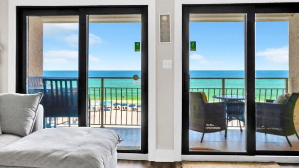 A room with a bed and a view of the ocean through large sliding glass doors. - Crystal Villas 12B (Destin)