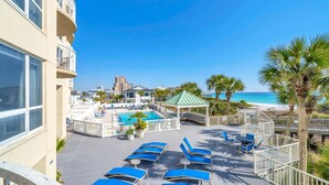 A rooftop pool area with lounge chairs, a small pool, and a view of the beach. - Hidden Dunes Gulfside 206 (Miramar Beach)