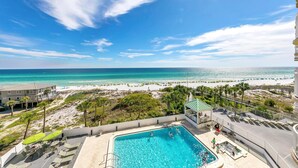 A pool area with a view of the beach and ocean. - Hidden Dunes Gulfside 502 (Miramar Beach)