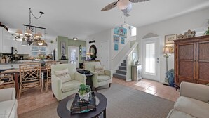 A spacious living area with a dining table, two sofas, a coffee table, and a ceiling fan. - Aventon (Miramar Beach)