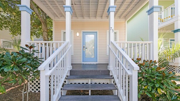 A porch with a blue door, white railings, and a number '75' on the post. - Pops Place (Santa Rosa Beach)