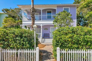 A two-story house with a balcony, a porch, and a front door. - La Bella Vita (Santa Rosa Beach)