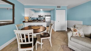 A compact living space with a kitchen, dining area, and a small seating area.