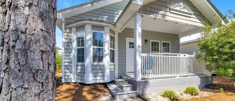 A single-story house with a porch, a mailbox, and a number '70' on the front.