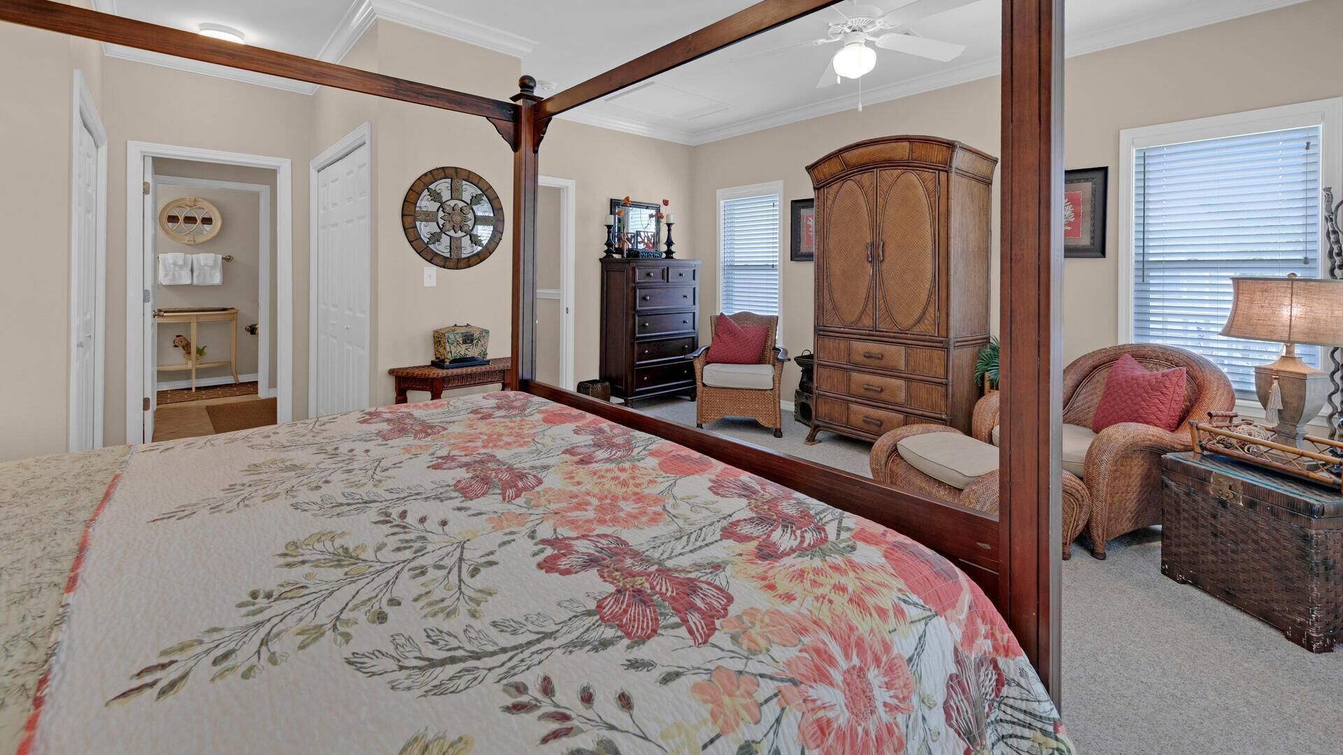 A bedroom with a four-poster bed, a dresser, a chair, and a cabinet.