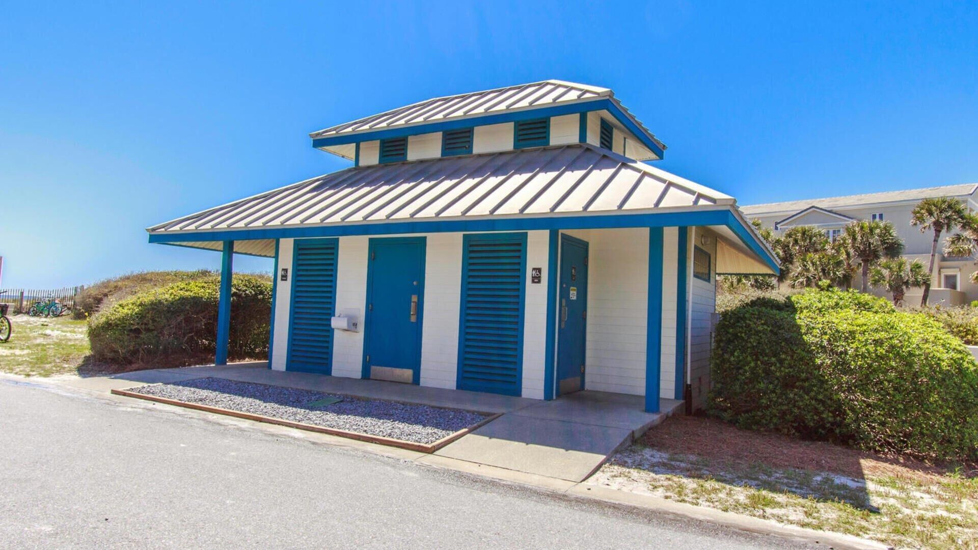 A two-story motel with a flat roof and blue trim.