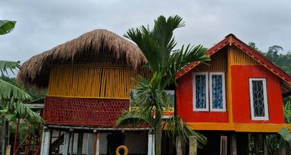 “Elevated wood cabin and bamboo lounge combo in a lush mountain valley.”