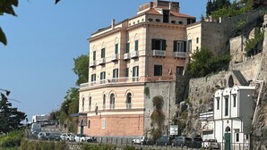 A multi-story building with a classical architectural style, featuring arched windows and balconies.