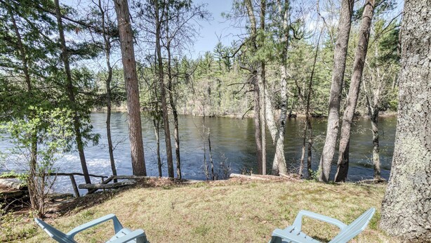 A lakeside view with two Adirondack chairs and a picnic table. - Edgewater Resort (Iron Mountain)