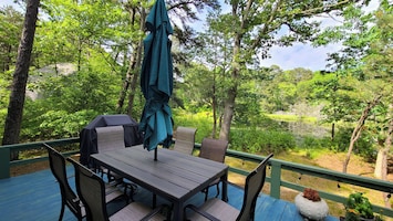 Pond view deck with gas grill and dining table