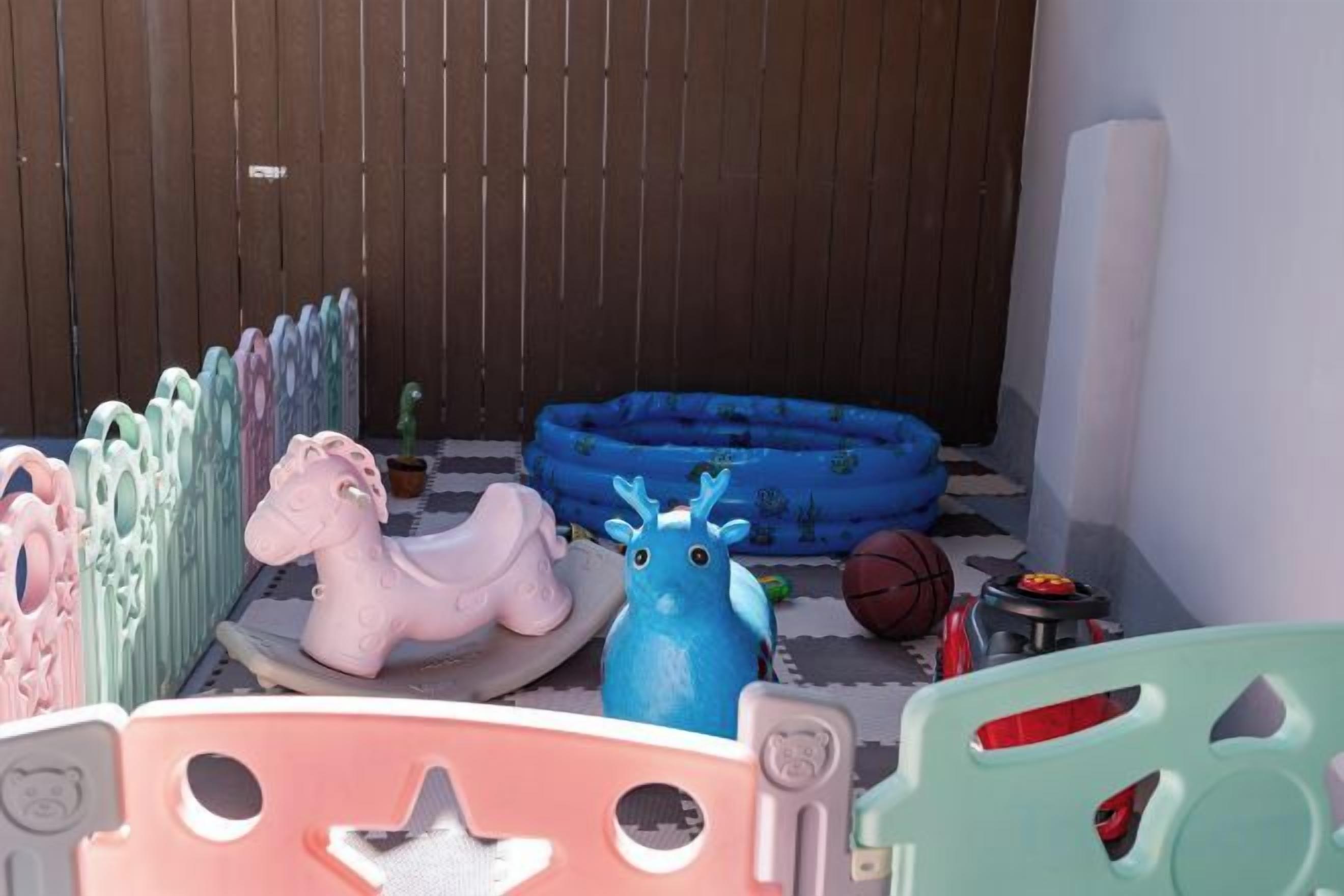 A children's play area with various toys and play structures.