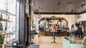 Un intérieur moderne avec un bar, des sièges et un présentoir à bouteilles.