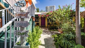 A colorful building with a staircase, a sign for 'Offices', and a sign for 'Bikes'.