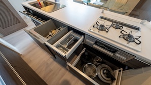 A modern kitchen with a built-in stove, stainless steel appliances, and a dishwasher.