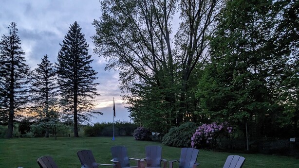A circular outdoor seating area with a fire pit surrounded by Adirondack chairs. - Perfect for Multiple Families- Close to Beach, Trails, Wineries, Breweries (South Haven)