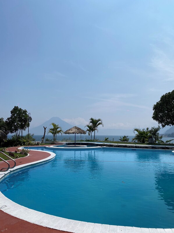 Outdoor pool, open 8:00 AM to 6:30 PM, pool umbrellas