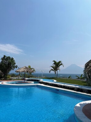 Outdoor pool, open 8:00 AM to 6:30 PM, pool umbrellas