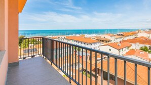 A balcony with a view of a coastal town and the sea. - Apartment Mauro by Interhome (San Vincenzo)