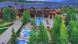 A resort with multiple buildings, a swimming pool, and a hot tub area. - Ski in, ski out resort at Grand Timber Lodge in beautiful Breckenridge, CO (Breckenridge)
