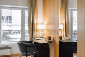 Enjoy a stylish retreat with a large window offering a view of a nearby building's unique facade.