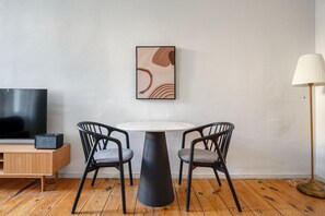Relax in a stylish room with a flat-screen TV, round table, and comfortable seating.