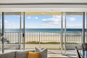 Een balkon met uitzicht op het strand en de oceaan.